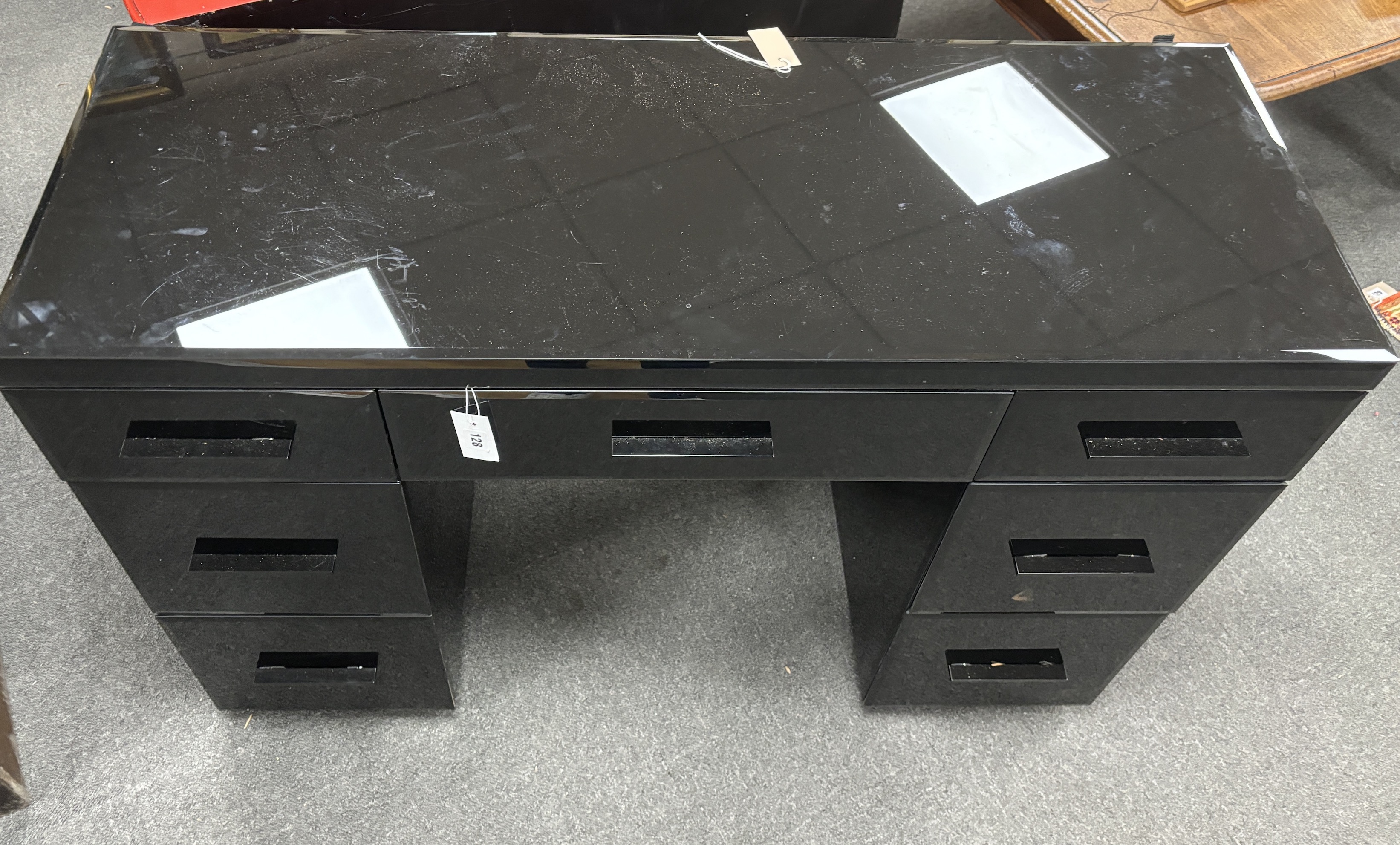 A contemporary black glass kneehole desk, width 121cm, depth 45cm, height 83cm